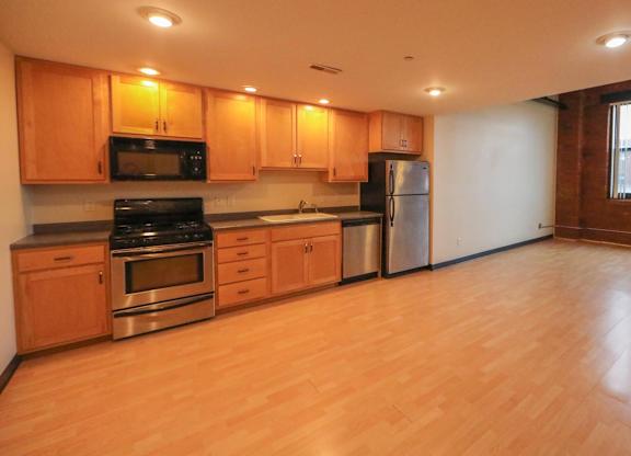 A kitchen with wooden cabinets and stainless steel appliances.