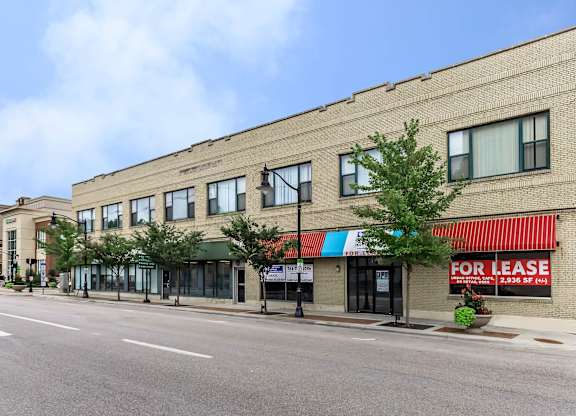 A building with a for lease sign on the front.