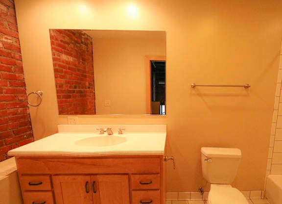 A bathroom with a white toilet and a white sink.
