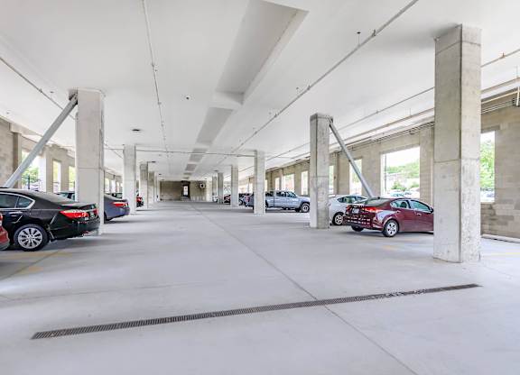 A parking garage with cars parked in it.
