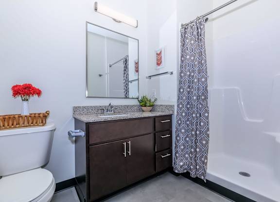 A white toilet sits next to a sink in a bathroom.