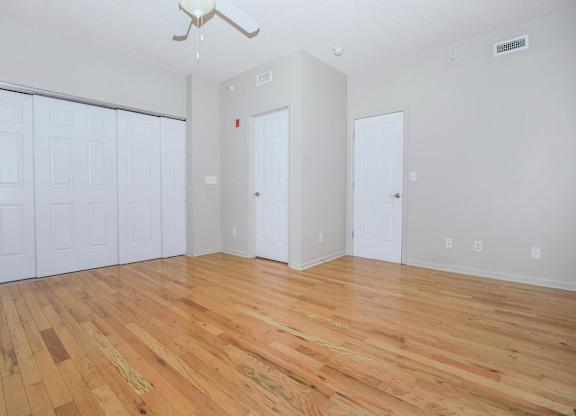 A room with wooden floors and white walls.
