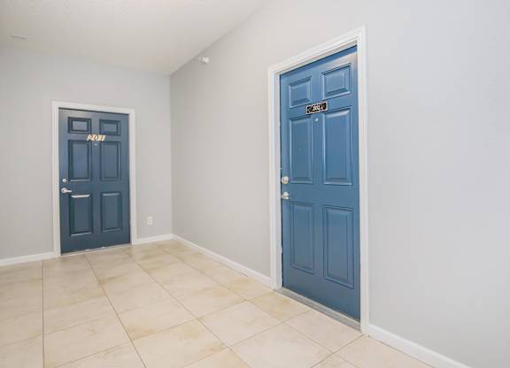 A room with two doors, one of which is blue.