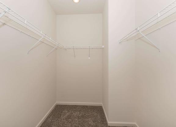 A small, empty room with a carpeted floor and white walls.