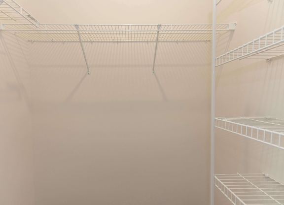 Empty shelves in a white refrigerator.