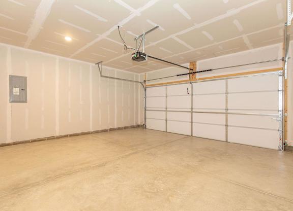 A garage with a white ceiling and a fan.
