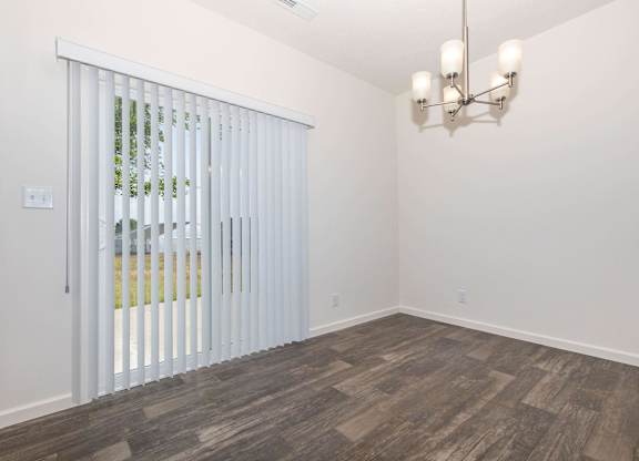 A room with a sliding door and a chandelier.