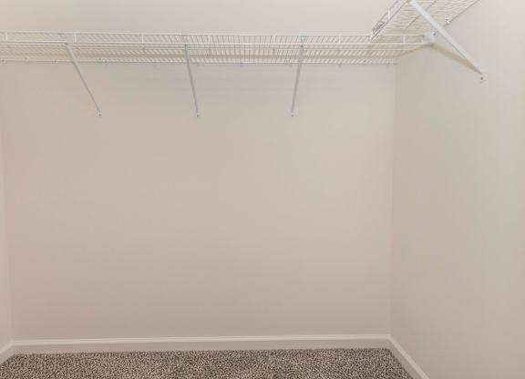 Empty room with a white closet rod.