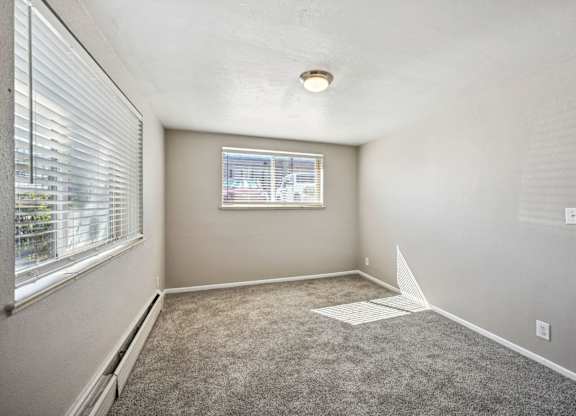 A room with a window and a carpeted floor. at Park at Fitzsimons Apartments, Aurora, MO, 80011