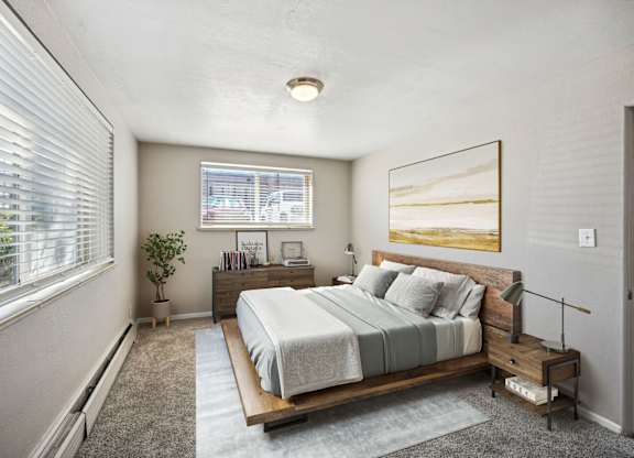 a bedroom with a bed and a window at Park at Fitzsimons Apartments, Colorado, 80011