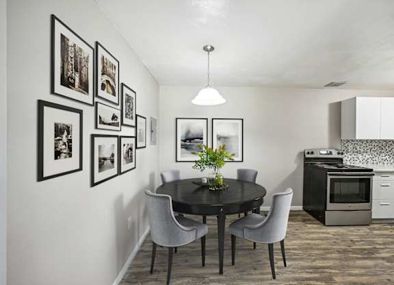 a kitchen and dining room with a table and chairs at Park at Fitzsimons Apartments, Aurora 80011