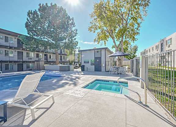 our apartments have a pool and a patio with chairs at Park at Fitzsimons Apartments, Colorado