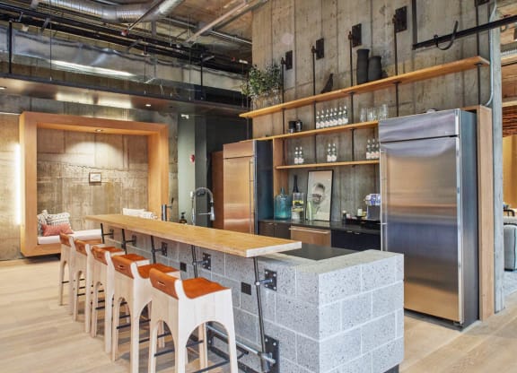 a kitchen with a counter and chairs in a restaurant at The Audubon New Haven, New Haven, CT, 06511