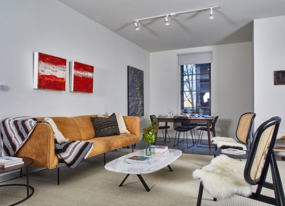 a living room with a couch and chairs and a dining room table at The Audubon New Haven, New Haven, CT, 06511