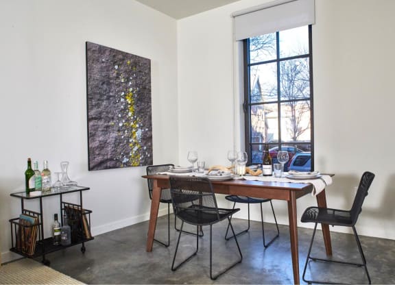 a dining room with a table and chairs and a window at The Audubon New Haven, New Haven, CT, 06511