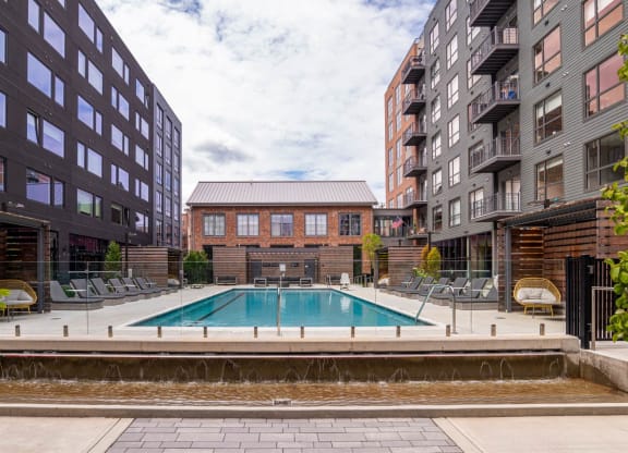 a swimming pool in between two tall buildings at The Audubon New Haven, Connecticut, 06511
