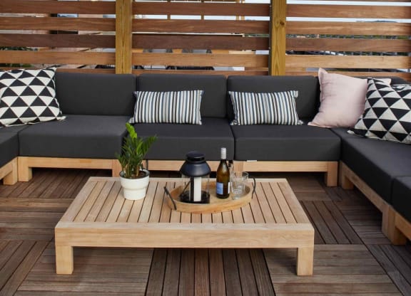 a wooden deck with couches and a coffee table at The Audubon New Haven, New Haven, CT