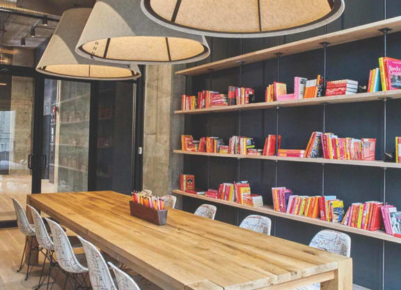 a dining room with a table and chairs and a bookshelf at The Audubon New Haven, Connecticut