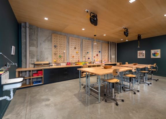 a dining room with tables and chairs and a wall with magnets on it at The Audubon New Haven, New Haven, CT, 06511