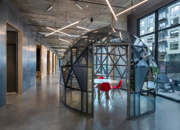 a room with a table and chairs and a geometric structure in the middle at The Audubon New Haven, New Haven, Connecticut