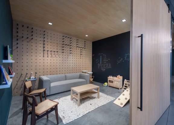 a living room with a couch and tables and a chalkboard at The Audubon New Haven, New Haven, CT, 06511