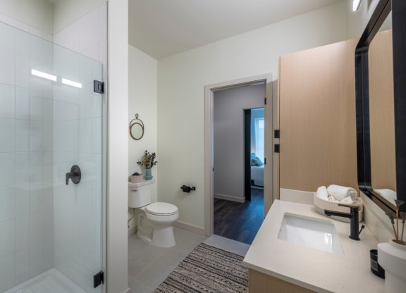 a bathroom with a shower toilet and sink at The Audubon New Haven, New Haven