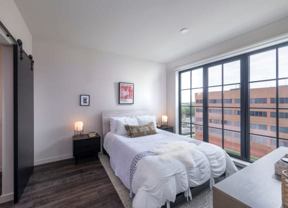 a bedroom with a bed and a large window at The Audubon New Haven, New Haven, CT, 06511