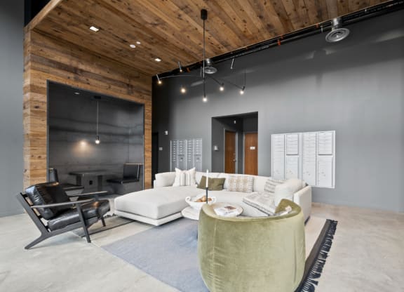 a living room with grey walls and a white couch and a table at The Audubon New Haven, New Haven, 06511