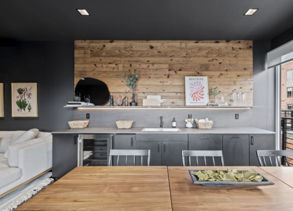 a kitchen with a wooden wall and a table with chairs at The Audubon New Haven, Connecticut, 06511