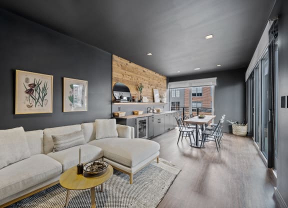 a living room with a couch and a table and a kitchen at The Audubon New Haven, New Haven, CT