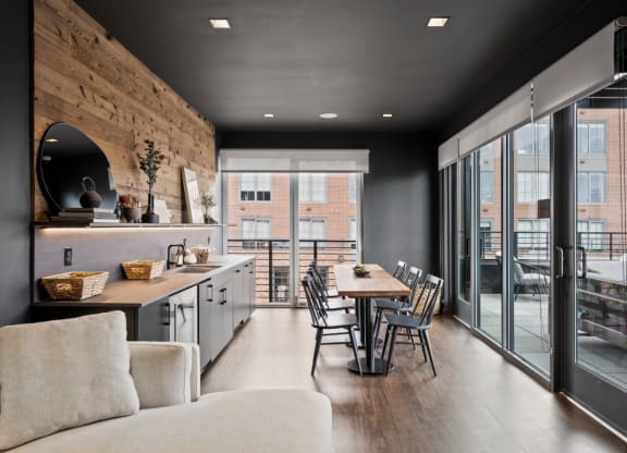 a kitchen and dining area with a table and chairs and sliding glass doors at The Audubon New Haven, New Haven, CT, 06511
