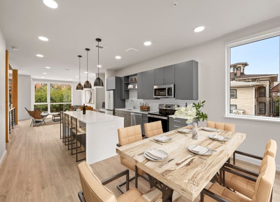 a kitchen and dining room with a table and chairs at The Audubon New Haven, New Haven, CT