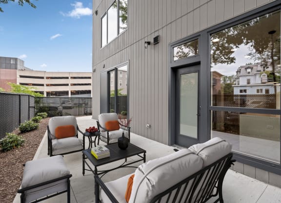 a patio with chairs and a table in front of a building at The Audubon New Haven, New Haven, 06511