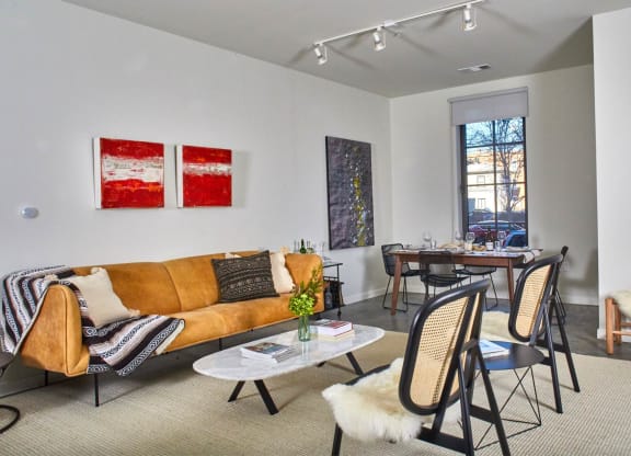 a living room with a couch and chairs and a dining room table at The Audubon New Haven, Connecticut, 06511
