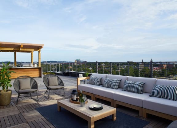 a rendering of a balcony with a couch and chairs at The Audubon New Haven, Connecticut