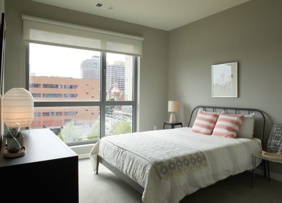a bedroom with a bed and a large window at The Audubon New Haven, Connecticut, 06511