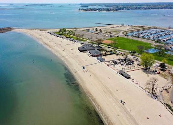 View of beach with a parking lot and a few buildings at The Villages at Saugatuck, Westport, CT, Connecticut