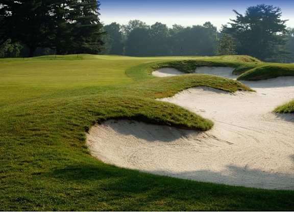 A golf course with a green and a sand trap at The Villages at Saugatuck, Westport, CT