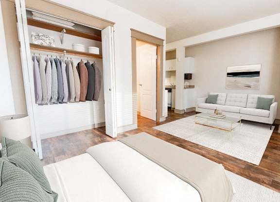 a living room with a white couch and a closet at Zindorf, Seattle, 98104