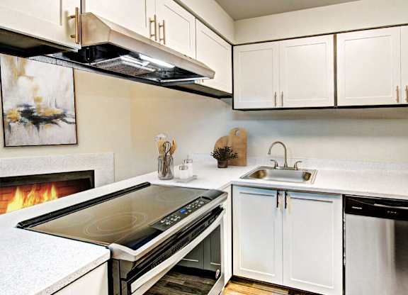 a kitchen with a stove top oven and a sink at Autumn Village, Milton, WA, 98354