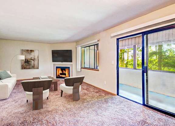 a living room with a couch and chairs and a fireplace at Autumn Village, Washington