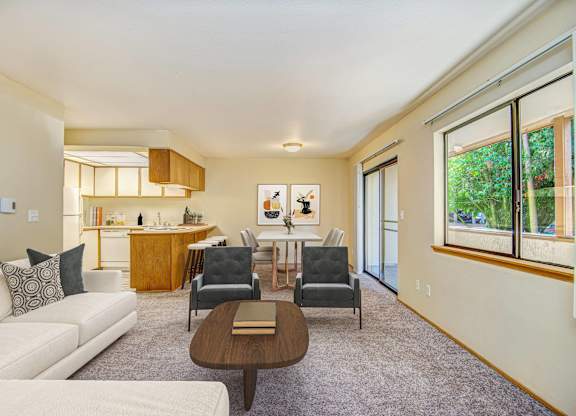 A living room with a white couch and a brown coffee table. at Autumn Village, Washington, 98354