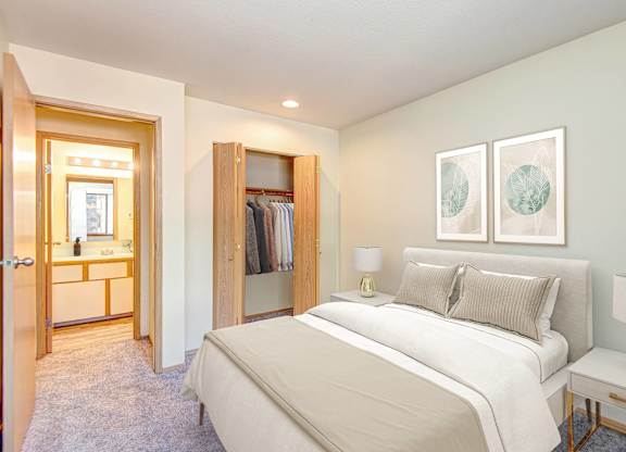A bedroom with a large bed and a walk-in closet. at Autumn Village, Washington, 98354
