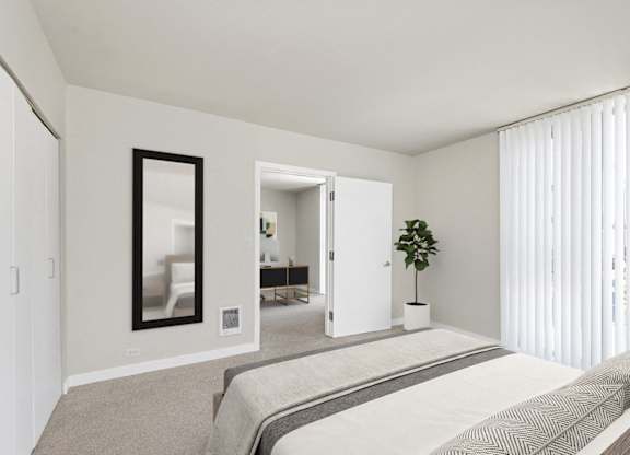 A bedroom with a large bed and a mirror on the wall.
