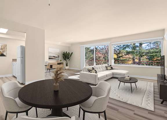 A modern dining room with a round table and chairs.