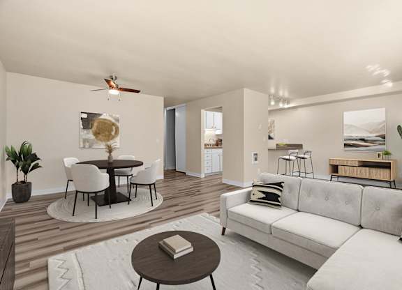 A modern living room with a white couch and a round table.
