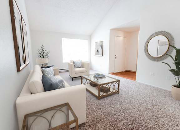 A living room with a white couch and a coffee table.