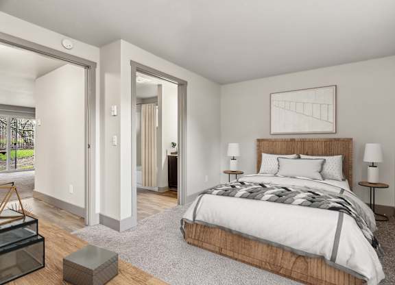 A bedroom with a large bed and a wooden headboard.