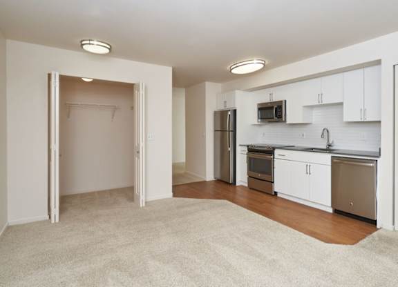 A kitchen with white cabinets and appliances is shown.