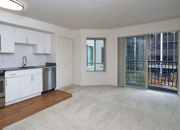 A kitchen with white cabinets and a stainless steel oven.
